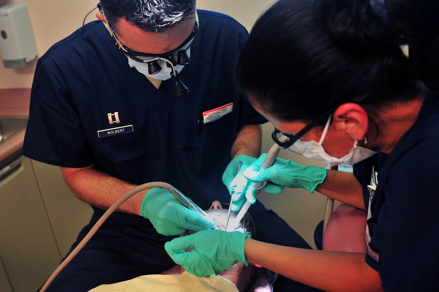 U.S. Air Force Capt. Christopher Wolbert, 20th Dental Squadron dentist, (left), works a patient’s filling July 20, 2011, Shaw Air Force Base, S. C. Shaw’s Dental Clinic is vital to mission readiness as all Airmen are required to have any dental issues taken care of prior to deployment. (U.S. Air Force photo by Airman 1st Class Ashley Gardner)(Released)