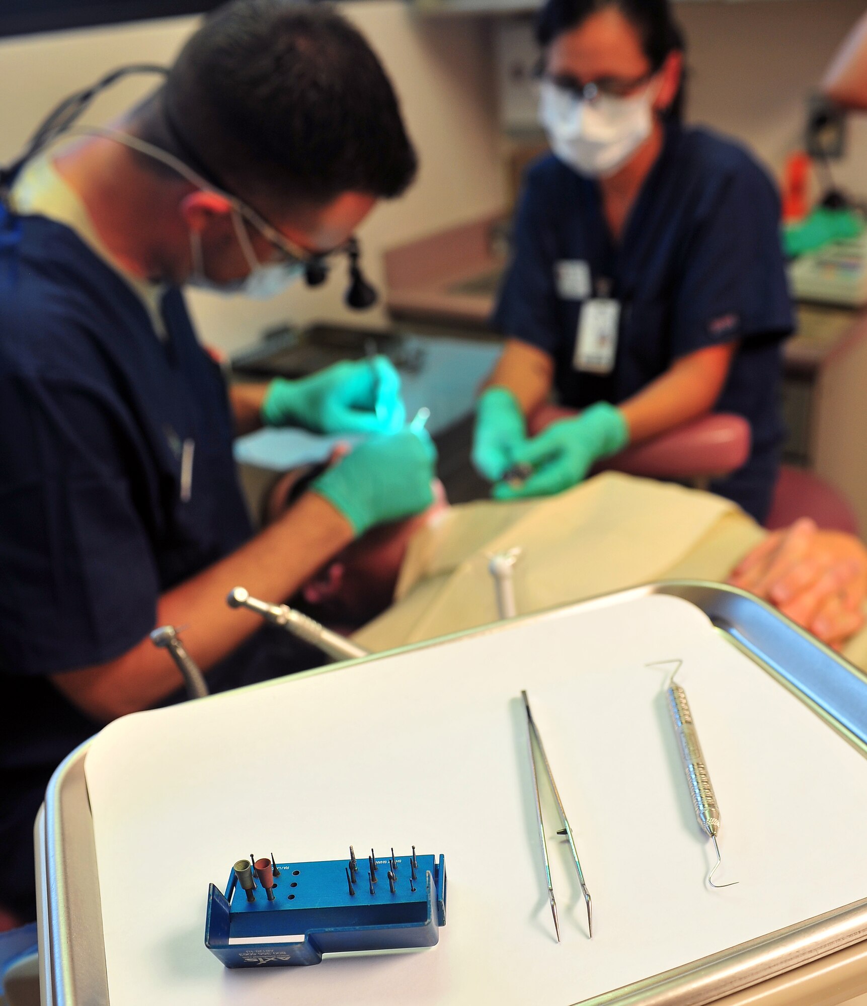 Important dental instruments used for routine dental checkups sit at an arm’s reach from U.S. Air Force Capt. Christopher Wolbert, 20th Dental Squadron dentist, (left), as he works with a patient July 20, 2011. Shaw’s Dental Clinic is vital to mission readiness as all Airmen are required to have any dental issues taken care of prior to deployment. (U.S. Air Force photo by Airman 1st Class Ashley Gardner)(Released)