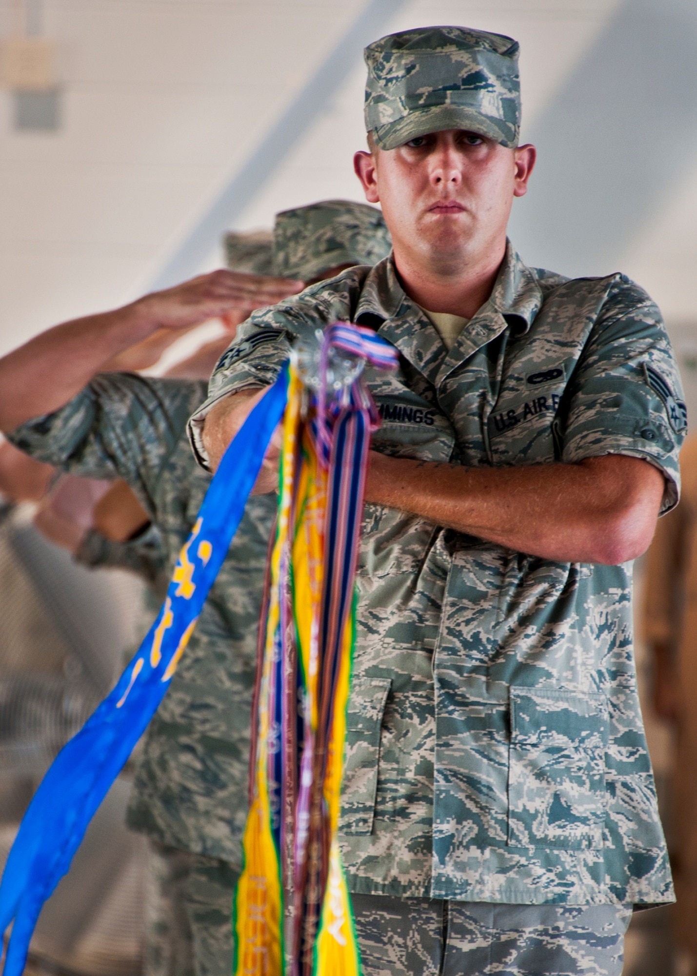 Senior Airman Shaun Cummings presents the 33rd Maintenance Squadron guidon during the 33rd Maintenance Group change of command ceremony July 22 at Eglin Air Force Base, Fla.  Col. Mark Fluker took command of the group from Marine Col. Laura Sampsel.  (U.S. Air Force photo/Samuel King Jr.)