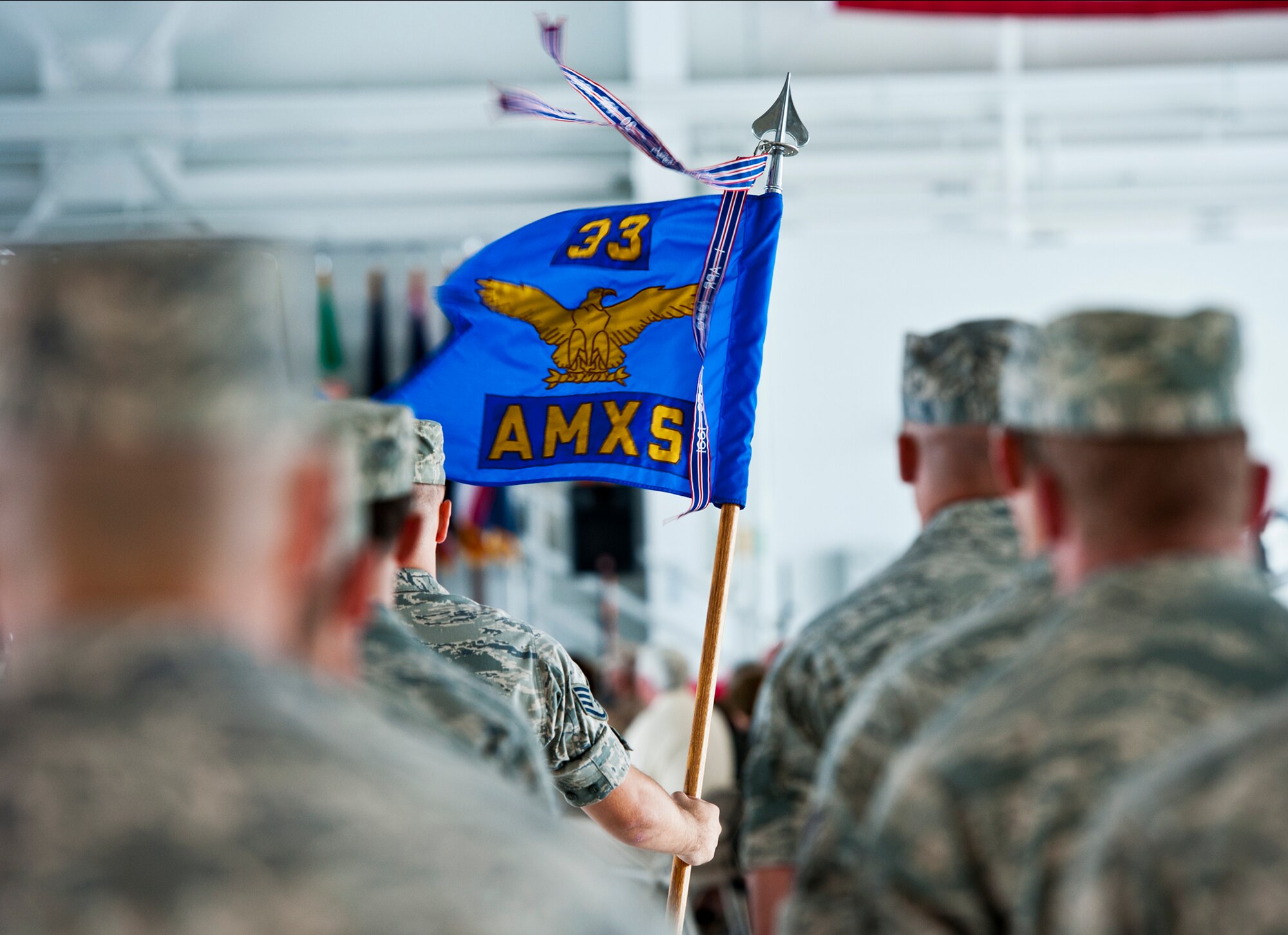 The 33rd Aircraft Maintenance Squadron guidon waves in the breeze during the 33rd Maintenance Group change of command ceremony July 22 at Eglin Air Force Base, Fla.  Col. Mark Fluker took command of the group from Marine Col. Laura Sampsel.  (U.S. Air Force photo/Samuel King Jr.)
