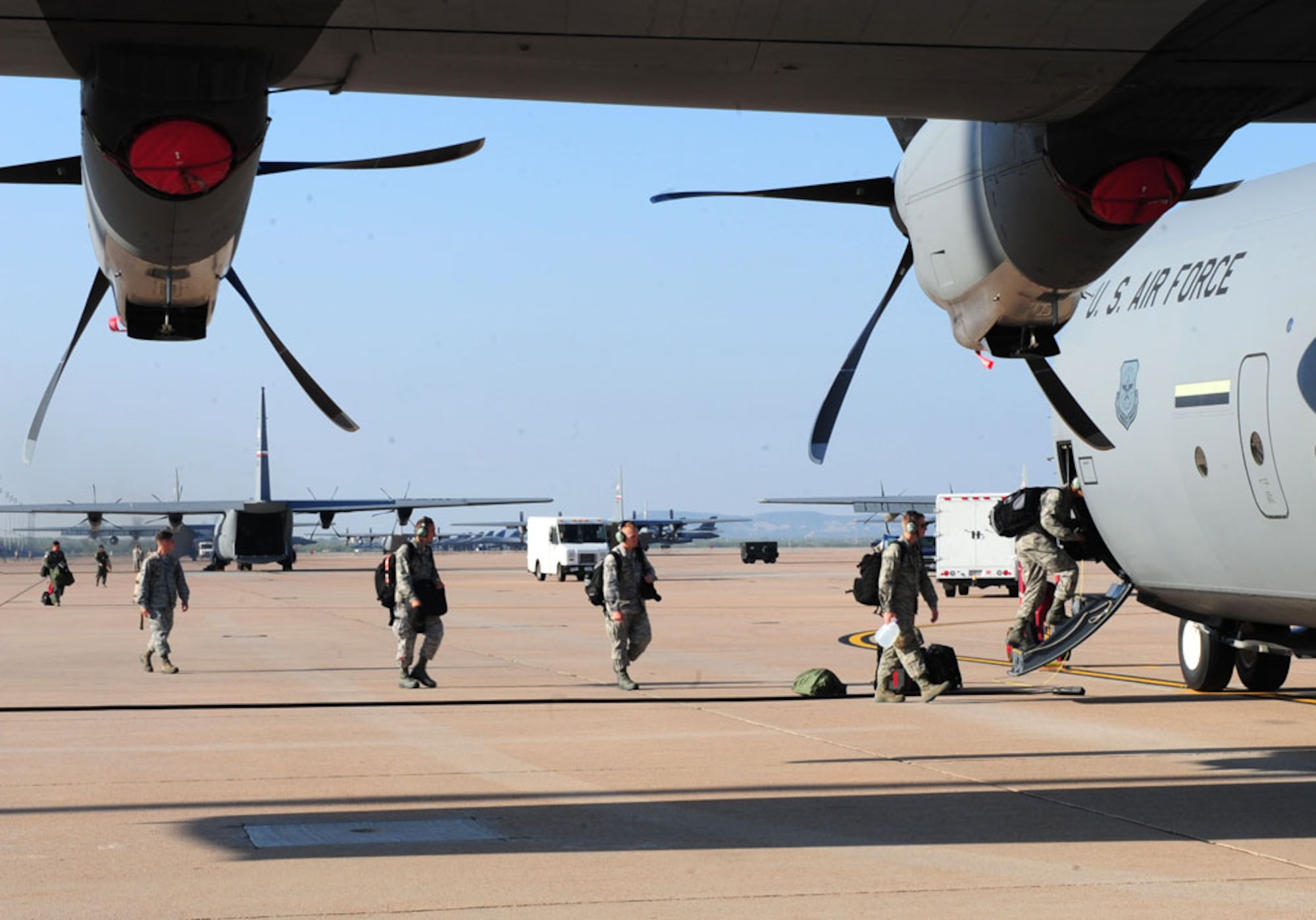 DYESS AIR FORCE BASE, Texas – Dyess Airmen board a C-130J before departing Dyess for the Air Mobility Command Rodeo at Joint Base Lewis-McChord, Wash., July 22. The AMC Rodeo is a biennial competition within the command. The international competition focuses on improving worldwide air mobility forces' professional core abilities. Competing in the rodeo are Airmen from the 317th Airlift Group, the 7th Security Forces Squadron and the 7th Logistics Readiness Squadron. (U.S. Air Force photo by Senior Airman Chelsea Browning/Released)