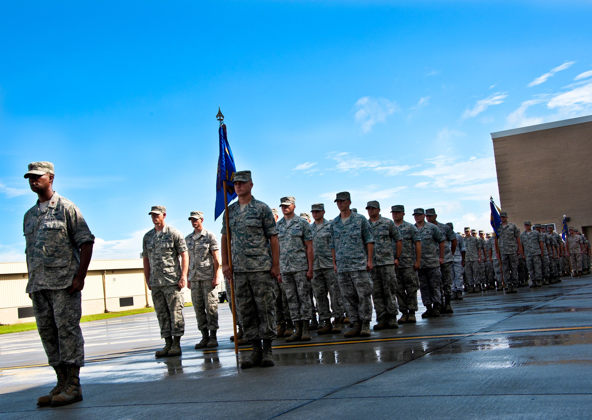 Three squadrons of maintainers stand at attention after marching by their new commander during the 33rd Maintenance Group change of command ceremony July 22 at Eglin Air Force Base, Fla.  Col. Mark Fluker took command of the group from Marine Col. Laura Sampsel.  (U.S. Air Force photo/Samuel King Jr.)