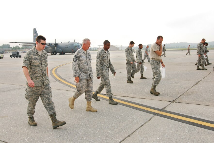 94th Maintenance Group personnel along with 94th Airlift Wing Command Chief, Chief Master Sgt. Wendell Peacock perform a FOD walk at Dobbins ARB, July 10.  (U.S. Air Force photo/ Brad Fallin)