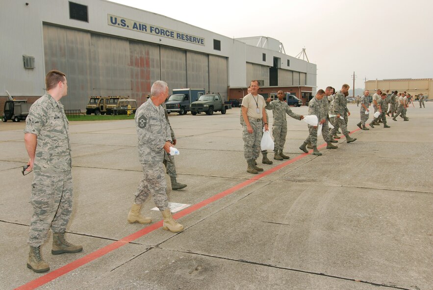 94th Maintenance Group personnel along with 94th Airlift Wing Command Chief, Chief Master Sgt. Wendell Peacock line up for a FOD walk at Dobbins ARB, July 10.  (U.S. Air Force photo/ Brad Fallin)