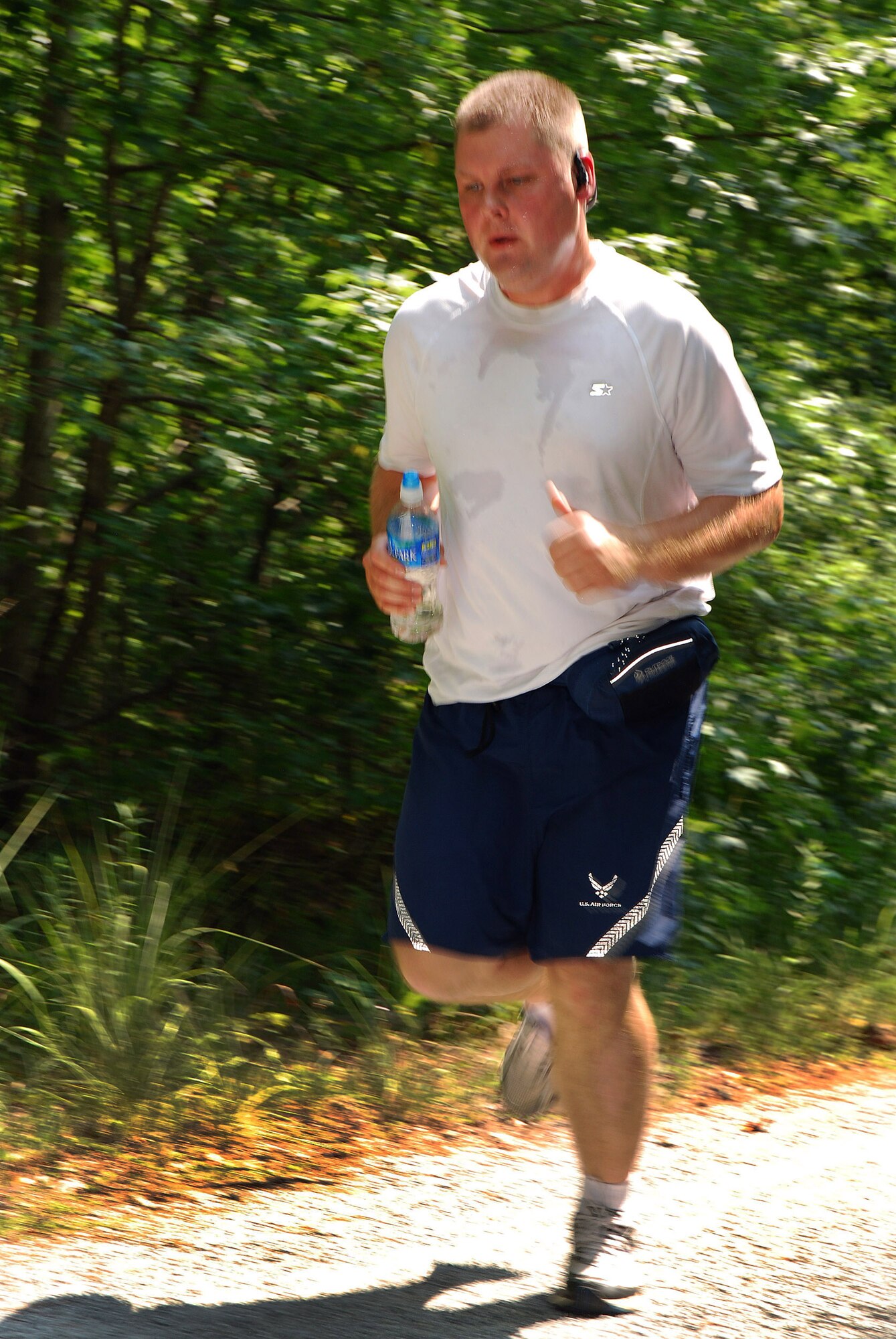 Tech. Sgt. Steve Griggs, 283rd Combat Communications Squadron, runs on the forested trail during the 2 mile Fun Run at Dobbins Air Reserve Base, Ga., July 20.  .  (U.S. Air Force photo/ Brad Fallin)