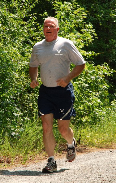 Senior Master Sgt. John Murray, 283rd Combat Communications Squadron, follows a forested trail during the 2 mile Fun Run at Dobbins Air Reserve Base, Ga., July 20.  (U.S. Air Force photo/ Brad Fallin)