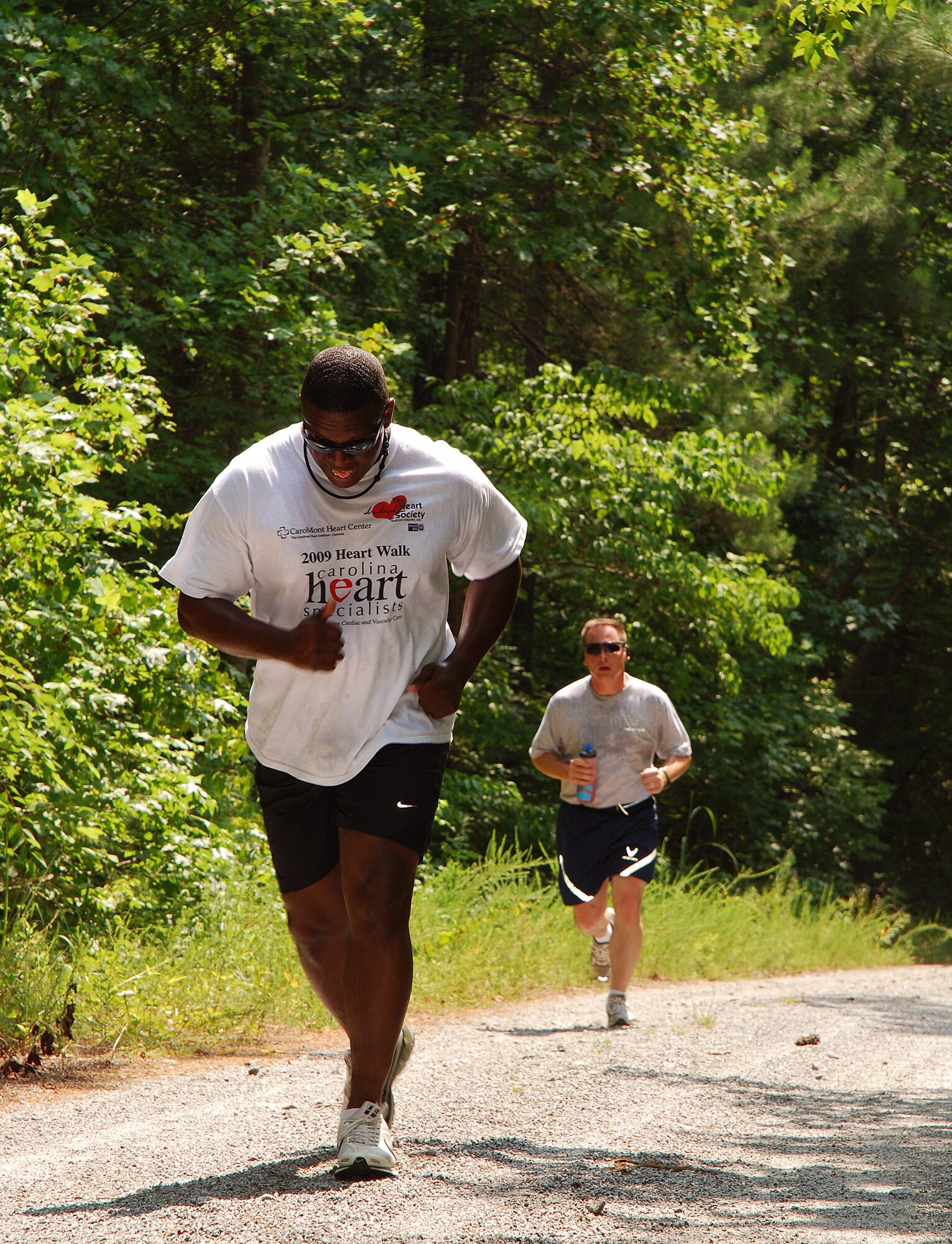Gunnery Sgt. John Goode, 4th Marine Logistics Group, is followed closely by Master Sgt. Steve Denton, 283rd Combat Communications Squadron, during the 2 mile Fun Run at Dobbins Air Reserve Base, Ga., July 20.  (U.S. Air Force photo/ Brad Fallin)