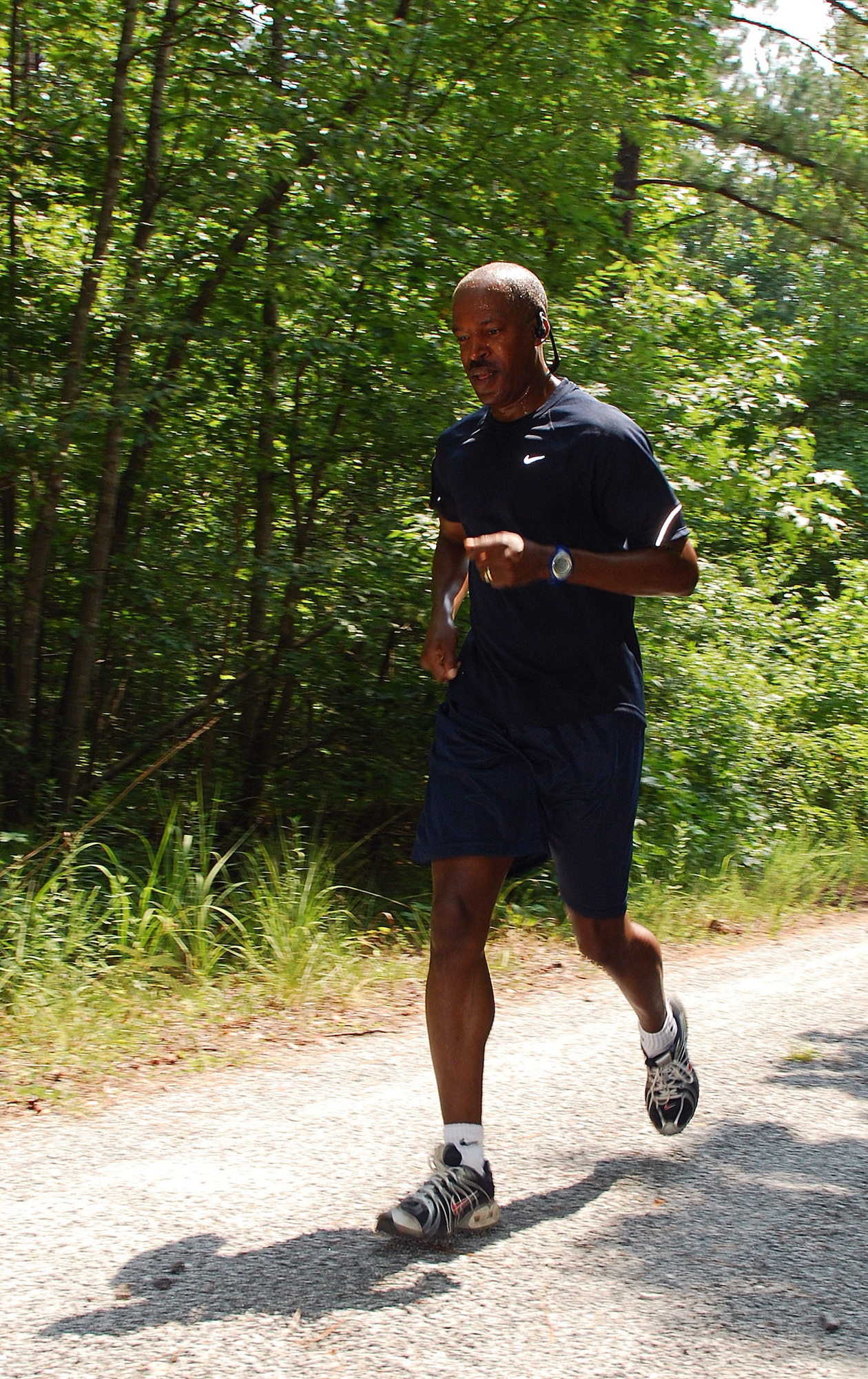 Master Sgt. Richard Bethune, 622nd Regional Support Group, works his way through the forested two mile Fun Run at Dobbins Air Reserve Base, Ga., July 20.  (U.S. Air Force photo/ Brad Fallin)