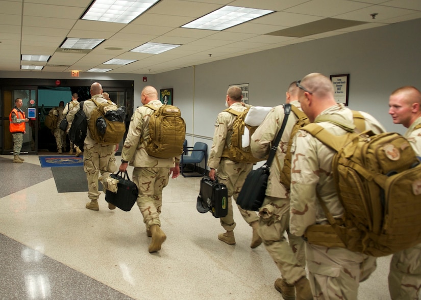 Port Security Unit 307 members depart the passenger terminal for their flight to the Middle East, July 22, 2011. While deployed, PSU 307 will be charged with providing harbor defense and security to ports, seaward approaches, and waterways within U.S. Central Command's area of responsibility and ensuring the free flow of personnel, equipment and commerce in the region. (U.S. Coast Guard photo by Petty Officer 2nd Class Michael Anderson/Released)