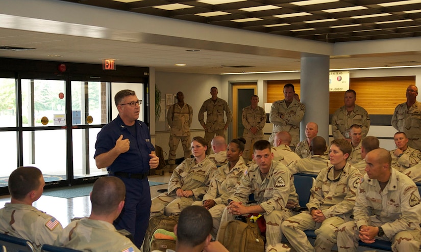 Capt. David Martin, Deployable Operations Group Senior Reserve Officer, speaks to Port Security Unit 307 members before they deploy to the Middle East in support of Operation New Dawn, July 22, 2011. While deployed, PSU 307 will be charged with providing harbor defense and security to ports, seaward approaches, and waterways within U.S. Central Command's area of responsibility and ensuring the free flow of personnel, equipment and commerce in the region. (U.S. Coast Guard photo by Petty Officer 2nd Class Michael Anderson/Released)