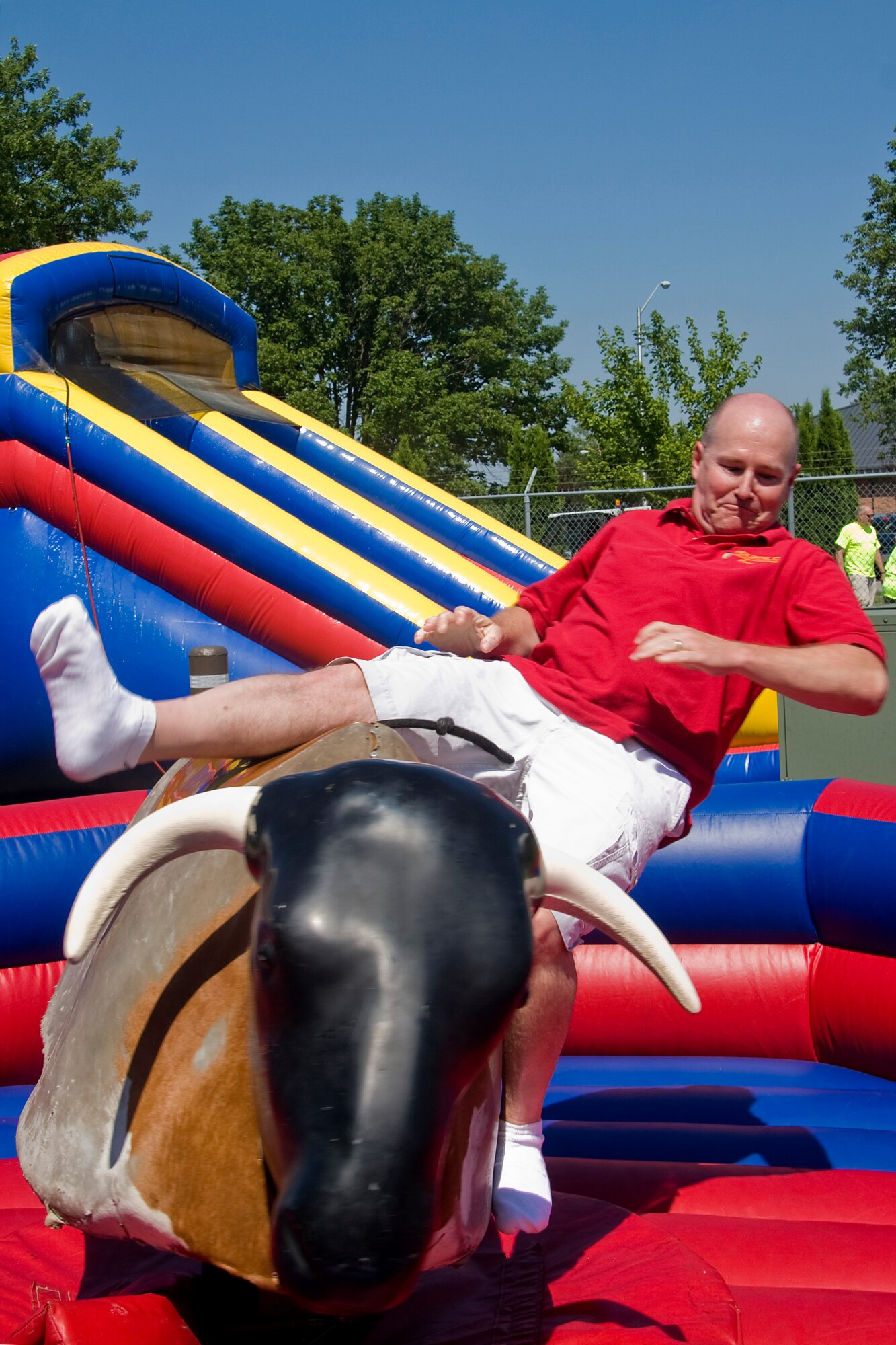GRISSOM AIR RESERVE BASE, Ind. -- Lt. Col. Daniel Harrison, 434th Force Support Squadron command, is bucked from a mechanical bull during this year's Family Appreciation Day picnic held during the July unit training assembly. Each year the 434th Air Refueling Wing thanks families for their support of reservists and base personnel during a picnic featuring displays, games and family activities. (U.S. Air Force photo/Tech. Sgt. Mark R. W. Orders-Woempner)
