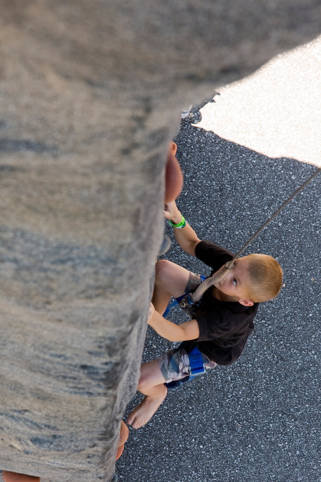 GRISSOM AIR RESERVE BASE, Ind. -- A young boy races to climb up a rock wall setup at this year's Family Appreciation Day picnic held during the July unit training assembly. Each year the 434th Air Refueling Wing thanks families for their support of reservists and base personnel during a picnic featuring displays, games and family activities. (U.S. Air Force photo/Tech. Sgt. Mark R. W. Orders-Woempner)
