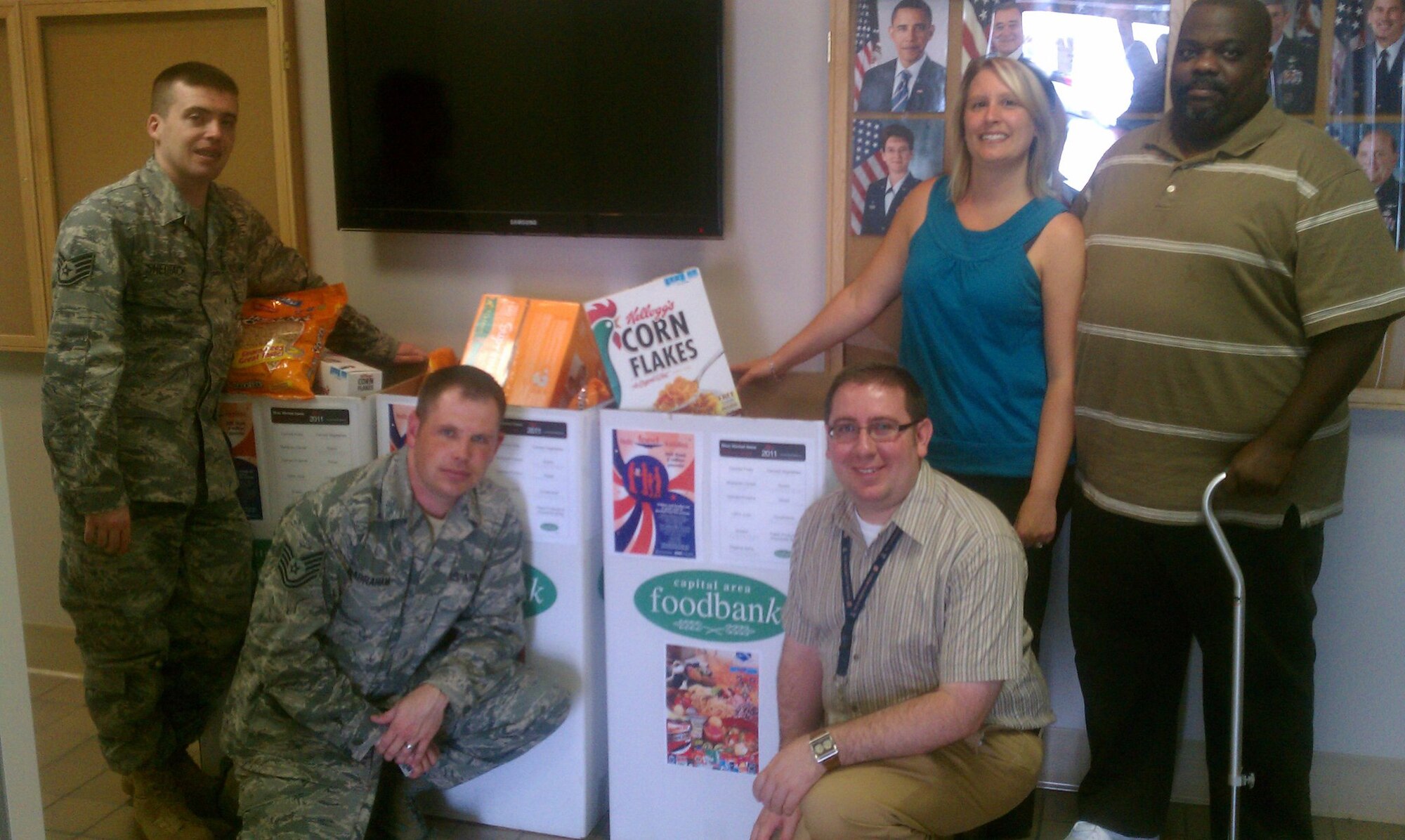Airmen from the 844th Communications Group and Air Force District of Washington Communications directorate demonstrate items which can be donated to the Capital Area Food Bank boxes, located throughout Joint Base Andrews, Md. and Joint Base Anacostia-Bolling, Washington D.C. Air Force District of Washington leaders have made 15,000 pounds of donated goods the goal for all combined AFDW units. To date, 1,500 have been collected. The deadline for all is August 31. (Photo by Ben Newell)