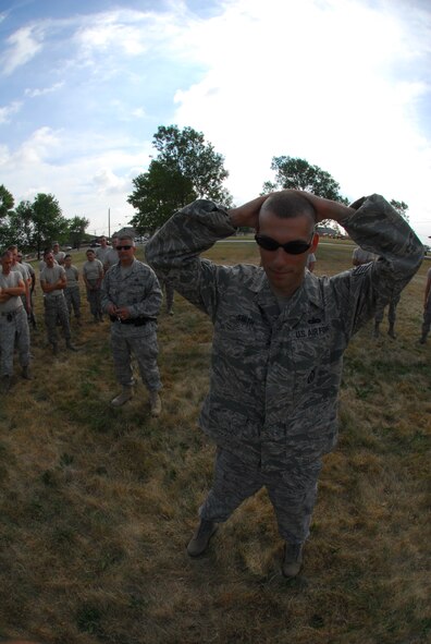 Master Sgt Marvin DiPilato, 914th Security Forces training manager instructs security forces augmentees on handcuffing techniques during the 914th Airlift Wing Unit Training Assembly July 22, 2011 Niagara Falls Air Reserve Station NY. The augmentees assist Military Law Enforcement with many aspects of base security. (U.S. Air Force photo by Staff Sgt. Andrew Caya)