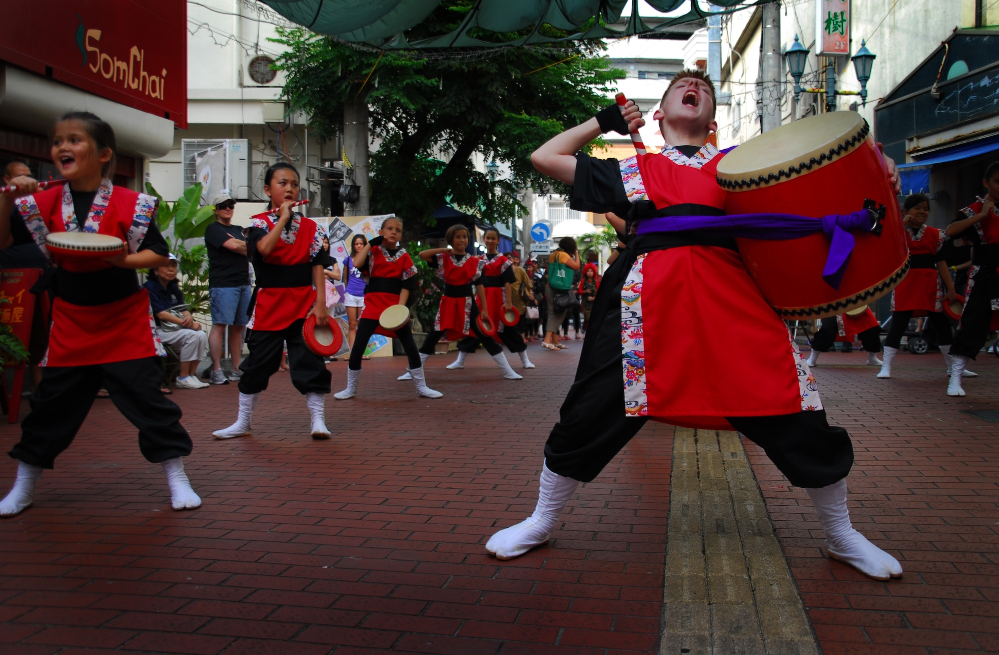 Students from Amelia Earhart Intermediate School on Kadena Air Base, Japan, perform Eisa dancing and Taiko drumming for locals, military members and their families in Okinawa City during the kick-off of the Kijimuna Festival on July 23, 2011. This annual, nine-day celebration is designed to showcase performing arts, workshops and other activities to youth. This year's event consists of performing arts companies from 14 countries and is the first time that American children have performed traditional Okinawan dance in this forum. (U.S. Air Force Photo by Tech. Sgt. Jocelyn Rich)