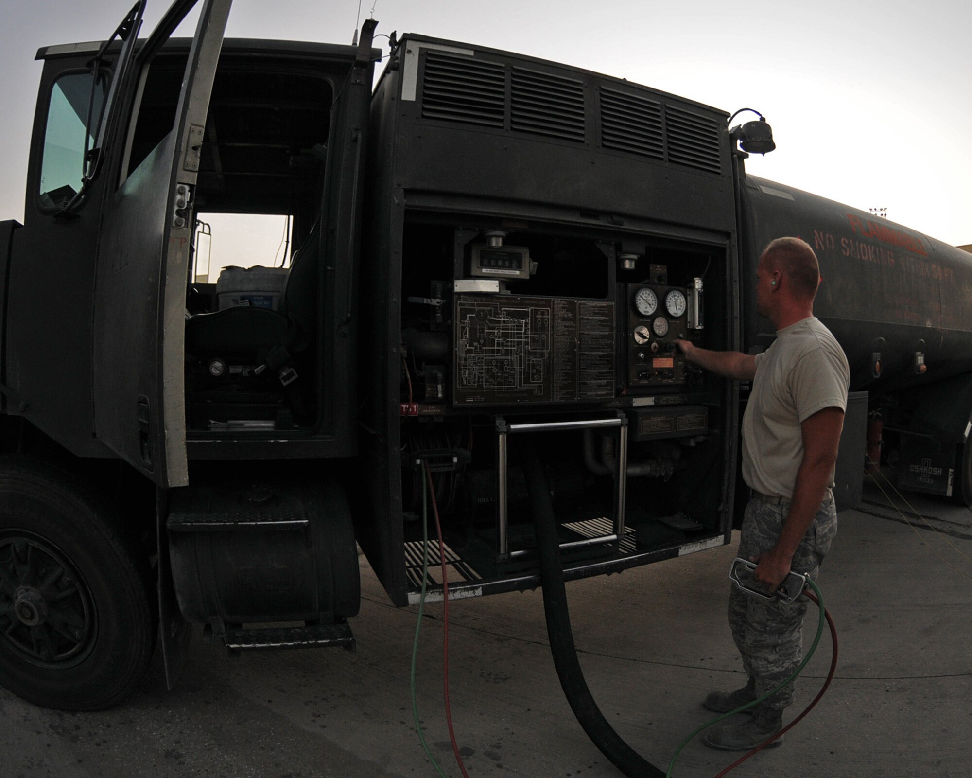 BAGRAM AIRFIELD, Afghanistan -- Airman 1st Class Johnson Barnett, 455th Expeditionary Logistics Readiness Squadron fuels distribution operator, refuels a C-130 Hercules aircraft July 13. Airman Barnett distributes up to 30,000 gallons of aircraft fuel per day. (U.S. Air Force photo by Senior Airman Krista Rose)