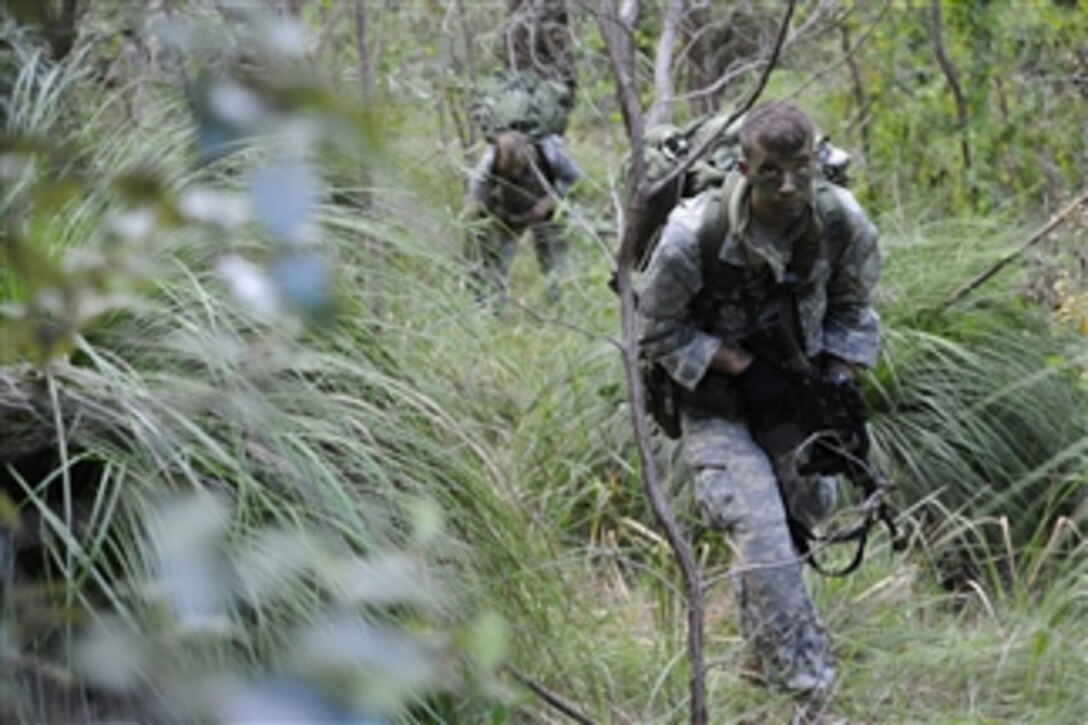 U.S. Army Pfc. Sam McQuaid, assigned to 1st Squadron, 158th Cavalry Regiment, patrols while on a reconnaissance mission to gather intelligence on the 31st Marine Expeditionary Unit's amphibious landing at Freshwater Bay, Australia, as part of the force-on-force training during Talisman Sabre 2011 on July 18, 2011.  Talisman Sabre is a combined biennial exercise between the U.S. and Australian militaries designed to enhance both nationsí ability to respond to regional contingencies.  