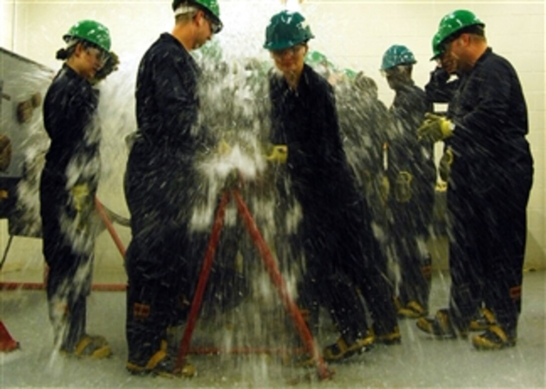 First class petty officers from Naval Support Activity Norfolk commands train at the Farrier Firefighting School damage control wet trainer USS Buttercup in Norfolk, Va., on July 15, 2011.  The event is part of phase two of CPO 365, a three-phase training process created by Master Chief Petty Officer of Navy Rick West to improve the induction process for new chief petty officers.  