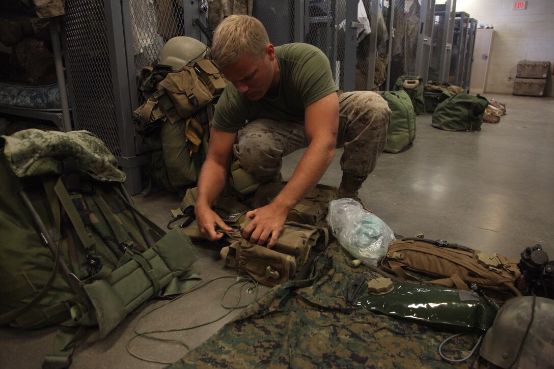 Petty Officer 3rd Class Anthony Brewton, hospitalman, a corpsman with 3rd Force Reconnaissance Company and Pensacola, Fla., native, prepares his gear for a training mission, July 25. The Marines will be heading to the Hawthorne Army Ammunition Depot, where they will gather intelligence on a target for a helicopter raid during the final exercise during Javelin Thrust.