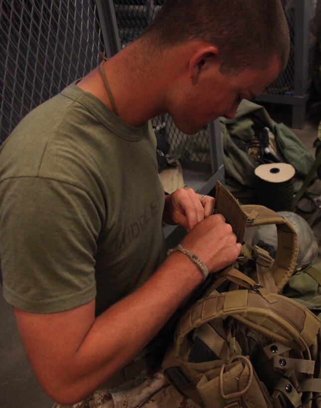 Lance Cpl. Daniel Middleton, a reconnaissance man with 3rd Force Reconnaissance Company, puts the finishing touches on his tactical vest, July 25. The Marines will be heading to the Hawthorne Army Ammunition Depot, where they will gather intelligence on a target for a helicopter raid during the final exercise during Javelin Thrust.