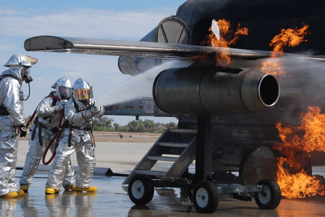 Crash, fire and rescue Marines with Marine Wing Support Squadron 471, Marine Wing Support Group 47, 4th Marine Aircraft Wing take part in training to put out fires on aircraft at the flight line at Marine Corps Air Station Yuma, Ariz., July 25. Marines use a burn simulator, designed to simulate an aircraft fire on a flight line. “The hands-on experience you get from the simulator is important and allows you to actually feel the heat when you do your job,” said Lance Cpl. Nicholas S. Brykovsky, a 26-year-old turret man from Princeton, Minn.