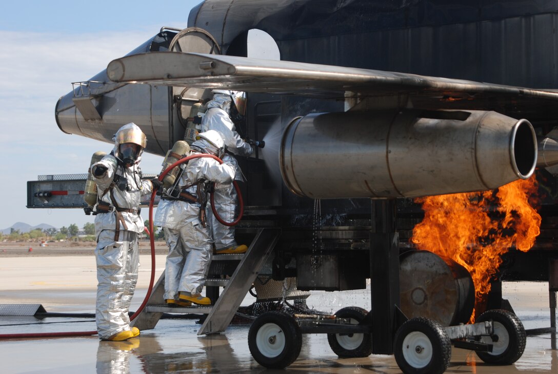 Crash, fire and rescue Marines with Marine Wing Support Squadron 471, Marine Wing Support Group 47, 4th Marine Aircraft Wing take part in training to put out fires on aircraft at the flight line at Marine Corps Air Station Yuma, Ariz., July 25. Marines used a simulator designed to provide a realistic fire burning an aircraft. The CFR Marines took part in the burn simulation training during training exercise Javelin Thrust.