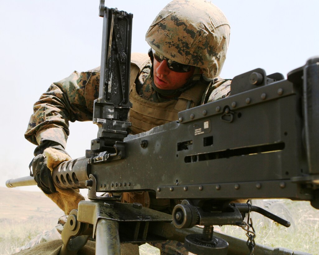 Lance Cpl. Chris Brigham, a machine gunner from Machine Gun Platoon, Support Company, Anti-Terrorism Battalion, 4th Marine Division, changes the barrel of a M2 .50 caliber machine gun here July 25 during Exercise Agile Spirit 2011.  Agile Spirit is designed to increase interoperability between Marines and the Georgian Armed Forces by exchanging and enhancing each other’s capacity in counterinsurgency and peacekeeping operations, including: small unit tactics, convoy operations, and counter-Improvised Explosive Device training.