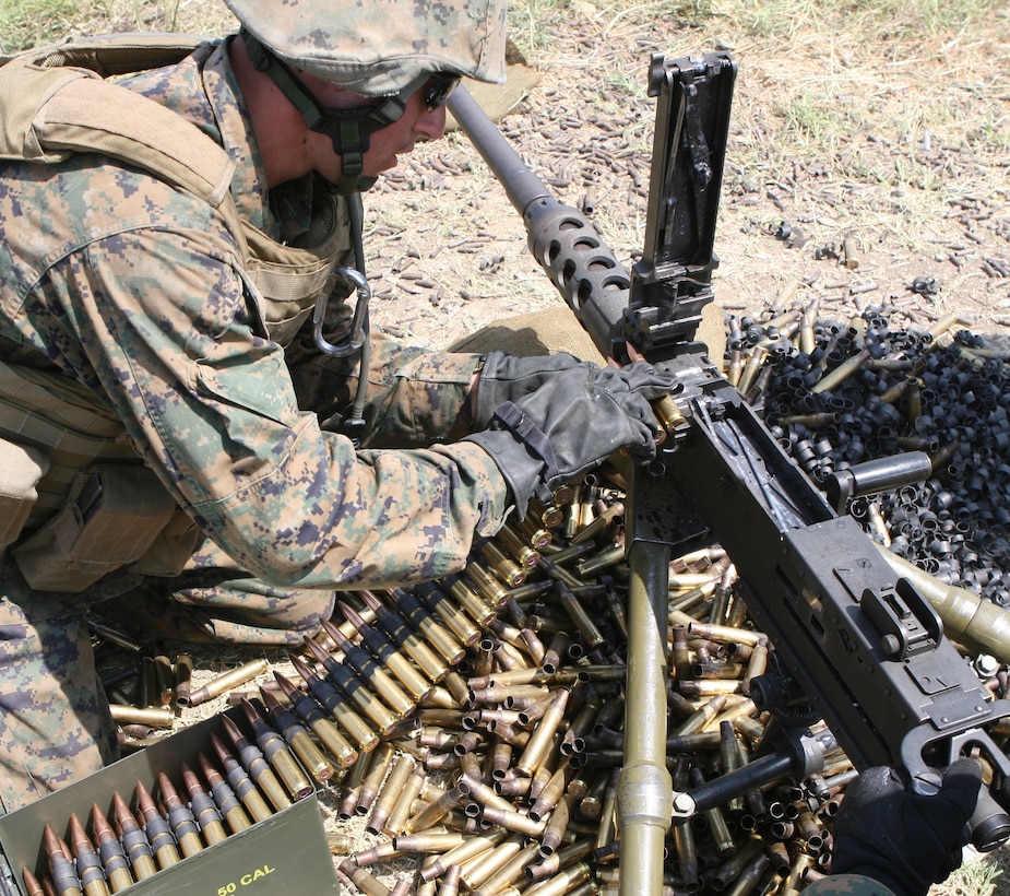 Lance Cpl. Chris Brigham, a machine gunner from Machine Gun Platoon, Support Company, Anti-Terrorism Battalion, 4th Marine Division, reloads a M2 .50 caliber machine gun here July 25 during Exercise Agile Spirit 2011.  Agile Spirit is designed to increase interoperability between Marines and the Georgian Armed Forces by exchanging and enhancing each other’s capacity in counterinsurgency and peacekeeping operations, including: small unit tactics, convoy operations, and counter-Improvised Explosive Device training.::r::::n::::r::::n::