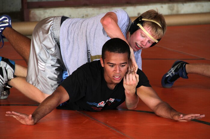 Nate Tigges, 15, from Woodbury, Minn., tries to expose Deion Sonsalla’s back from the par terre position during a free-style training session at the All-Marine Wrestling Camp July 26. Tigges will be a sophomore at East Ridge High School. Sonsalla, 16, from Eau Claire, Wis., will be a junior at North High School. For additional imagery from the event, visit www.facebook.com/rstwincities.