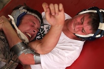 Tucker Breitung, 17, from Prior Lake, Minn., tries to wiggle out of a submission hold from his wrestling partner Matt Kahnke, 17, from Prior Lake Minn., during a free-style training session at the All-Marine Wrestling Camp July 26. Breitung and Kahnke will both be seniors at Prior Lake High School. For additional imagery from the event, visit www.facebook.com/rstwincities.