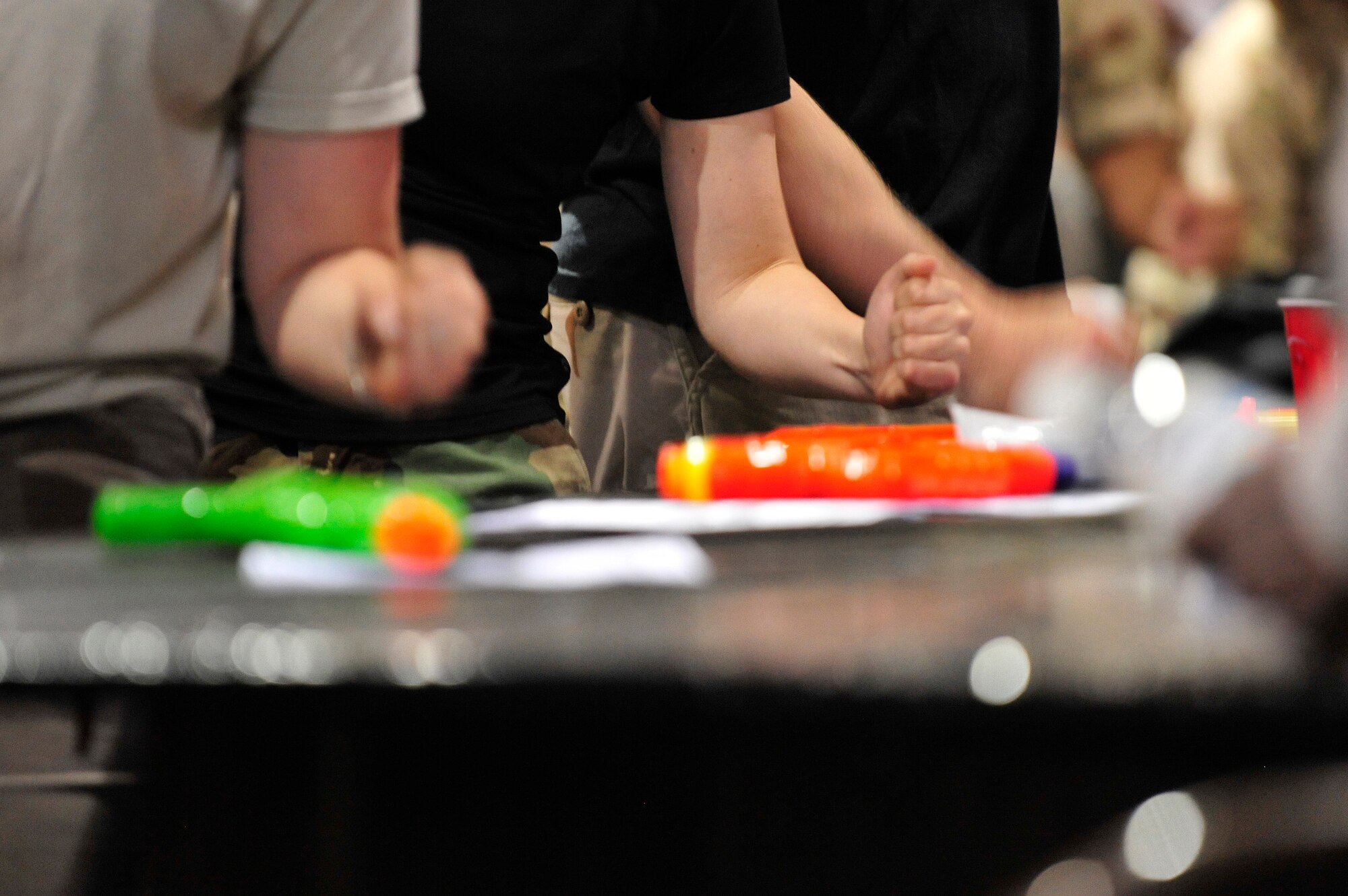 MISAWA AIR BASE, Japan -- Members of Misawa Air Base pound on the table instead of clapping at the 35th Fighter Wing's Combat Dining-Out, July 22. Clapping at a combat dining-out is against the rules and is punishable by drinking from the grog. (U.S. Air Force photo/Staff Sgt. Nathan Lipscomb/Released)