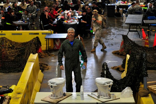 MISAWA AIR BASE, Japan -- Col. Al Wimmer, 35th Fighter Wing vice commander, steps up to the grog as punishment for throwing food during the 35th Fighter Wing's Combat Dining-Out, July 22. The grog, which is a foul concoction of beverages, is used to punish those who break the rules during a combat dining-out. (U.S. Air Force photo/Staff Sgt. Nathan Lipscomb/Released)  