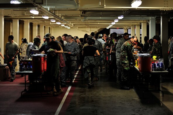 MISAWA AIR BASE, Japan -- Members of Misawa Air Base move through the chow line during the 35th Fighter Wing's Combat Dining-Out, July 22.  Combat dining-outs are a formal military function that brings together units from across the base to build esprit de corps. (U.S. Air Force photo/Staff Sgt. Nathan Lipscomb/Released)