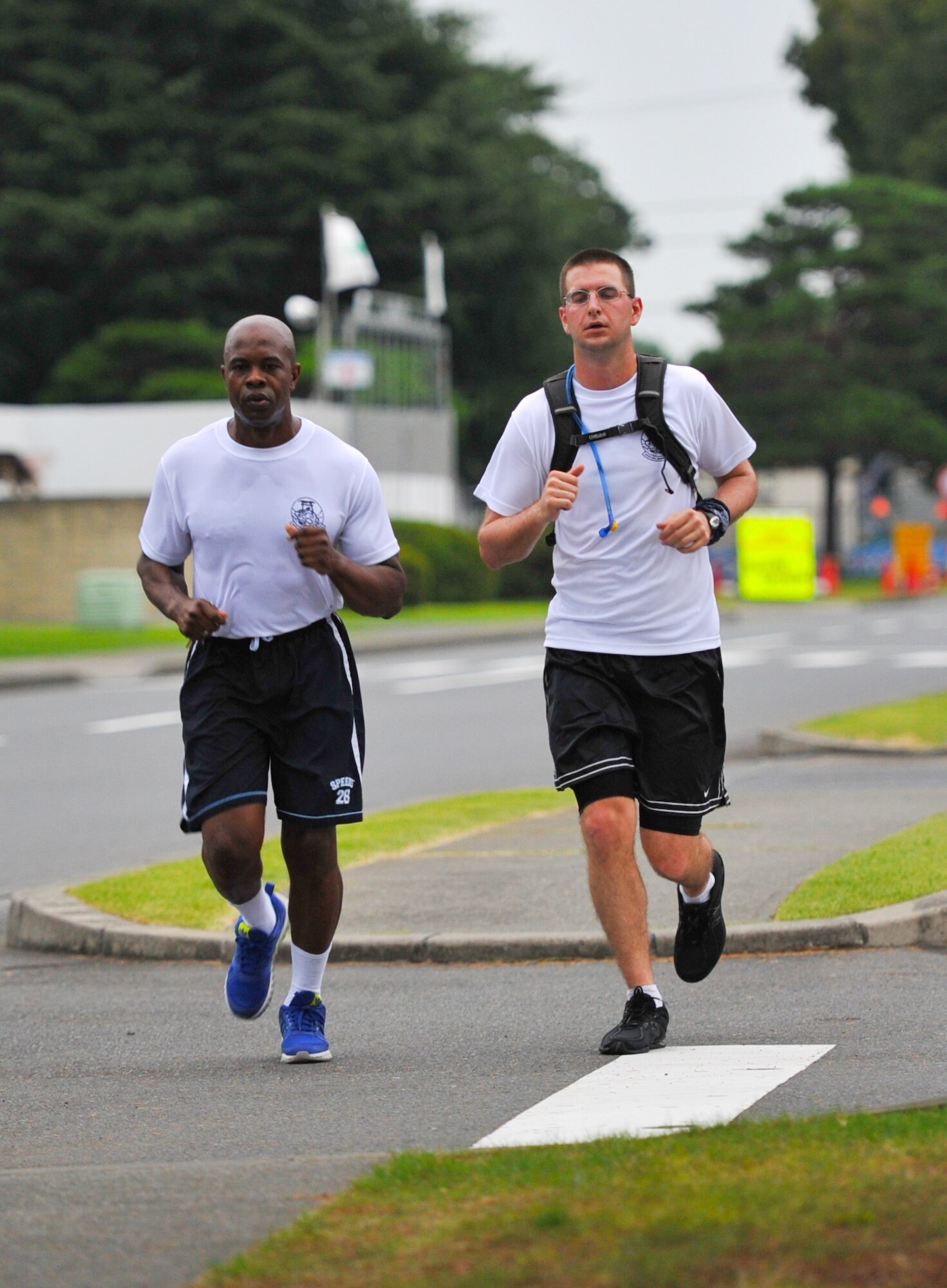 YOKOTA AIR BASE, Japan -- Airmen from the 374th Civil Engineer Squadron run together during the first annual "Running of the Bulls" event at Yokota Air Base, Japan, July 27, 2011. "Running of the Bulls" is held in order to promote morale and physical fitness within the squadron. (U.S. Air Force photo/Airman 1st Class Krystal M. Garrett) 
