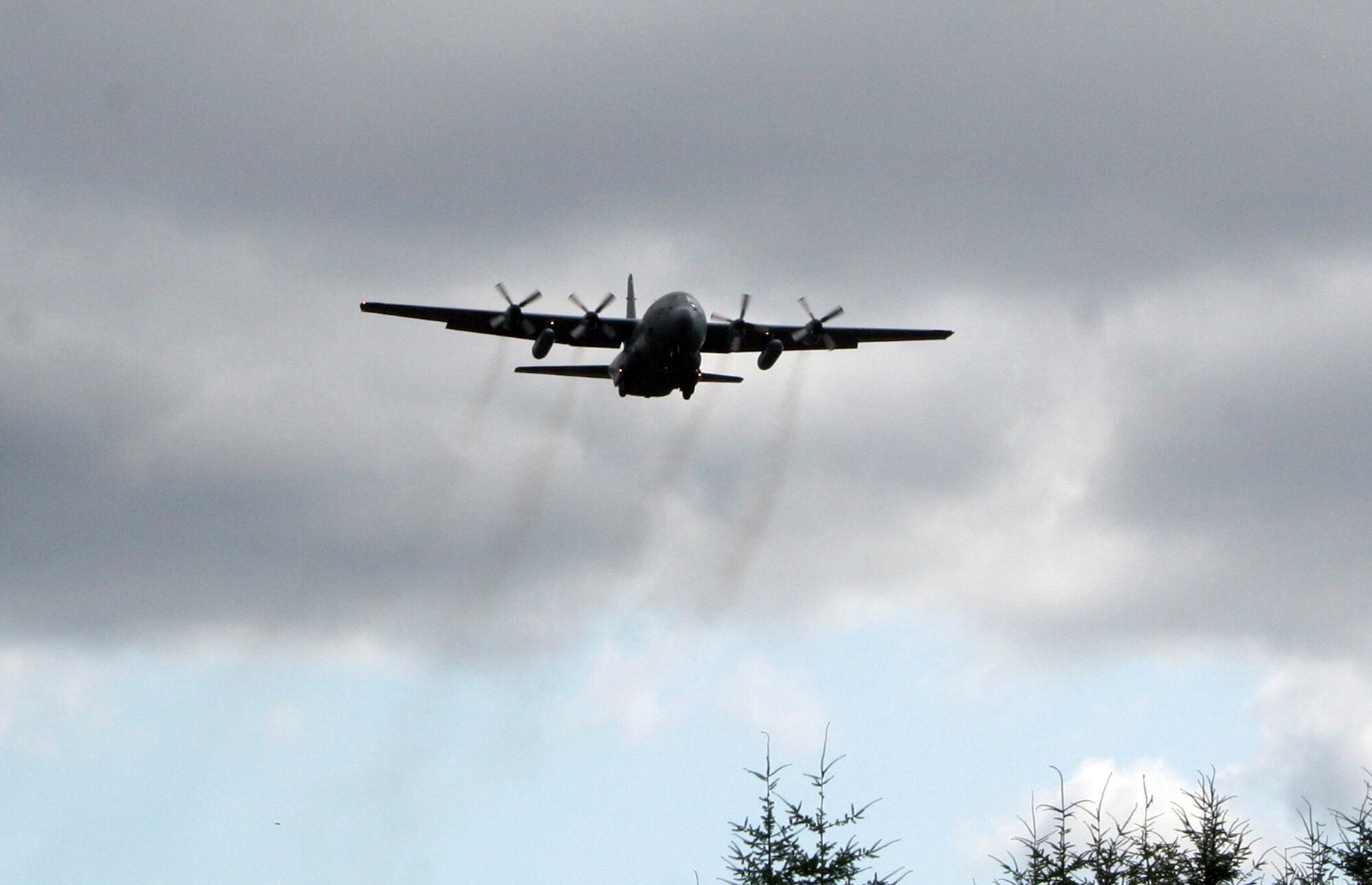 A C-130 Hercules participating in Air Mobility Rodeo 2011 returns from a competition sortie to Joint Base Lewis-McChord, Wash., on July 26, 2011. Rodeo 2011, sponsored by the Air Mobility Command, is the Mobility Air Force's readiness competition. This competition focuses on improving worldwide air mobility forces' professional core abilities. More than 150 teams and 3,000 people from the Air Force, and Air Force Reserve, as well as allied nations are participating in Rodeo. (U.S. Air Force Photo/Master Sgt. Scott T. Sturkol)