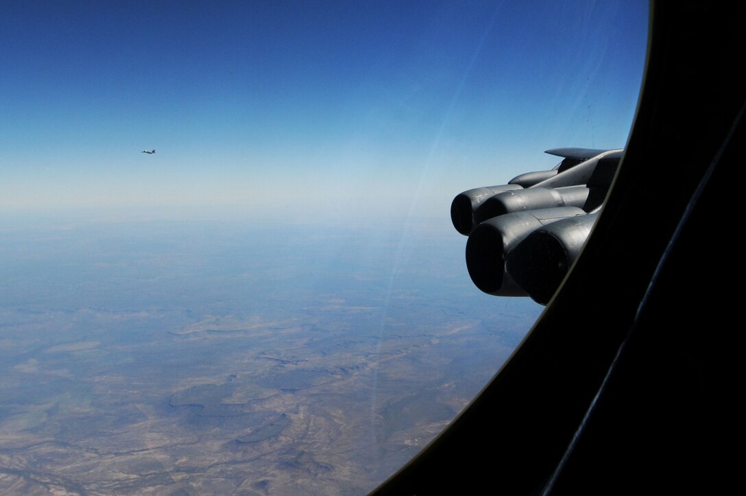 An F-18 "Super Hornet" falls into formation as an escort for a B-52 Stratofortress from the 96th Expeditionary Bomb Squadron, as part of Talisman Sabre, July 25. Exercise Talisman Sabre 2011 involves 30,000 Defense personnel from Australia and U.S. air, land and maritime forces. The Exercise took place at a range of Defense training
areas predominantly in Queensland and the Northern Territory. (U.S. Air Force photo/ Senior Airman Carlin Leslie)
