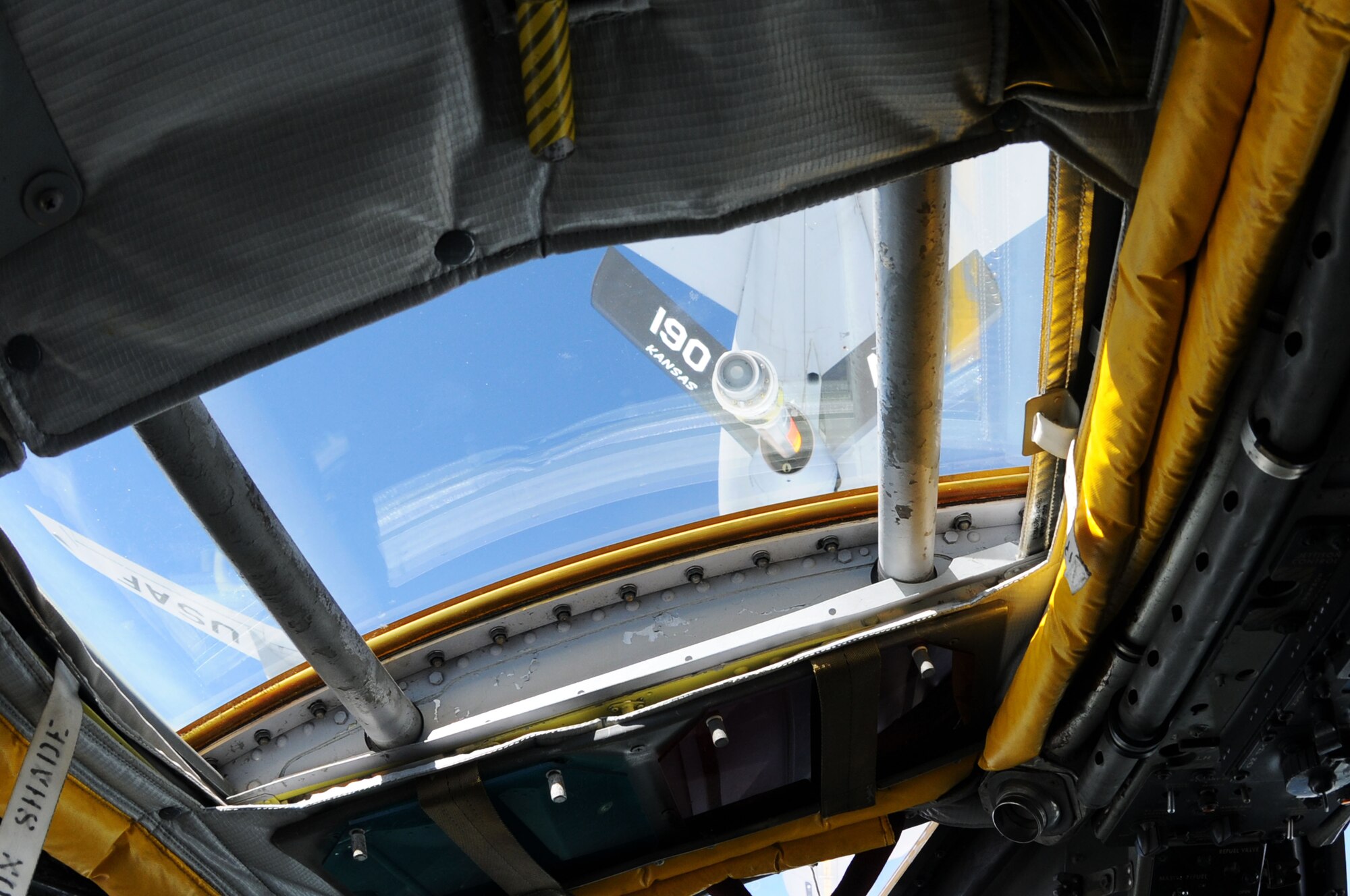 The boom of a KC-35 from the 190th Air Refueling Wing, Topeka, Kansas, is seen through the pilots over-head window as a B-52 Stratofortress from the 96th Expeditionary Bomb Squadron lines up to receive fuel, July 25. When the two jets connect, the KC-135 will transfer 80,000 pounds of fuel to the B-52. (U.S. Air Force photo/ Senior Airman Carlin Leslie)

