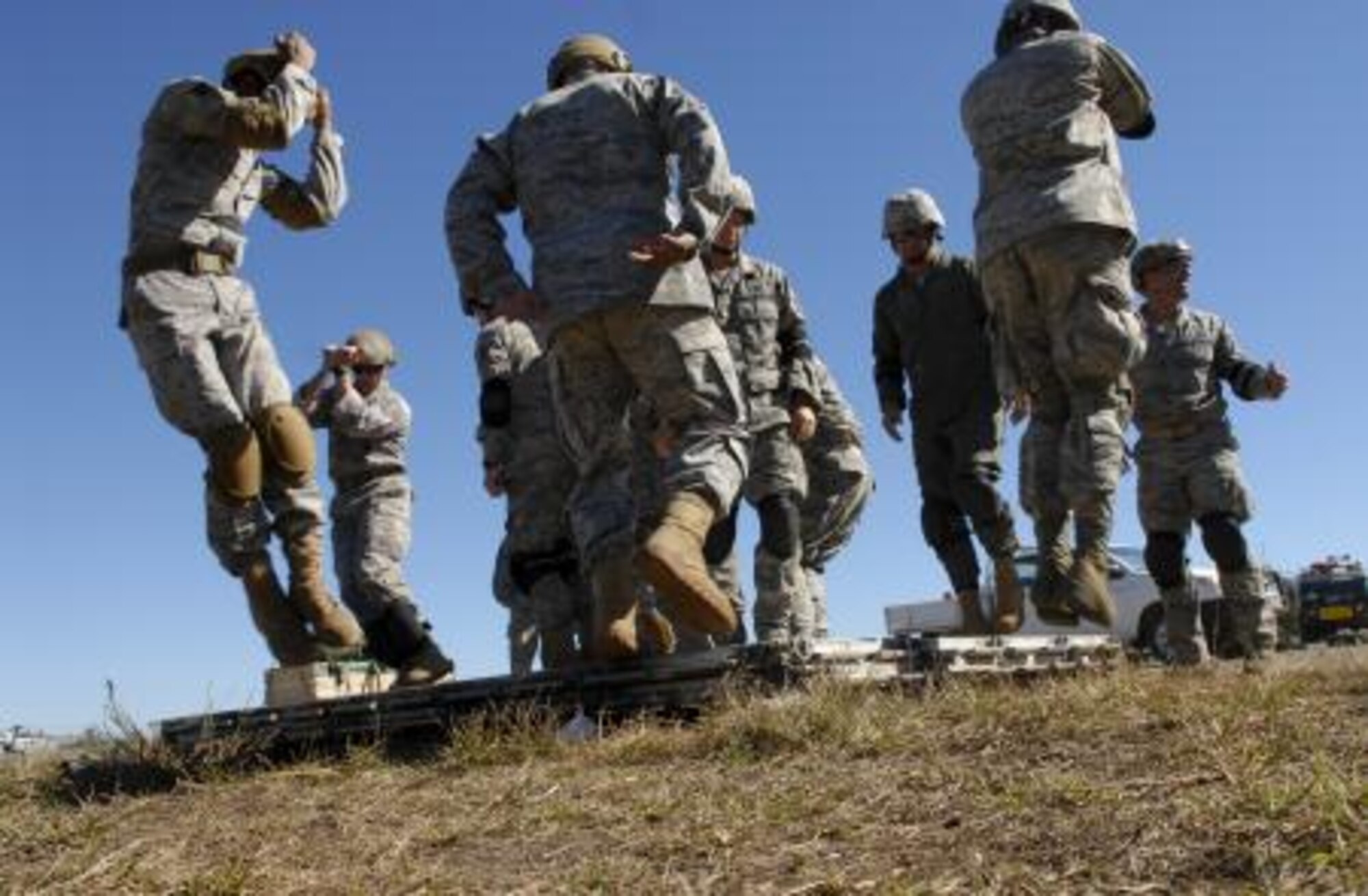 Members from the 36th Contingency Response Group here practice parachute landing postions prior to a jump during Talisman Sabre 2011. All jumpers must conduct pre-jump training prior to any jump. Talisman Sabre 2011 is an exercise designed to train U.S. and Australian forces to plan and conduct combined task force operations to improve combat readiness and interoperability on a variety of missions from conventional conflict to peacekeeping and humanitarian efforts. (Photo by Sara Csurilla)