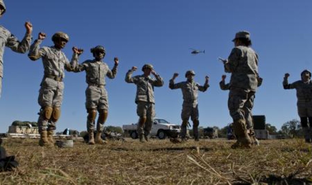Staff Sgt. Daisy Salas briefs fellow members of the 36th Contingency Response Group here, prior to a jump during Talisman Sabre 2011. All jumpers must conduct pre-jump training before to any jump. Talisman Sabre 2011 is an exercise designed to train U.S. and Australian forces to plan and conduct combined task force operations to improve combat readiness and interoperability on a variety of missions from conventional conflict to peacekeeping and humanitarian efforts. (Photo by Sara Csurilla)