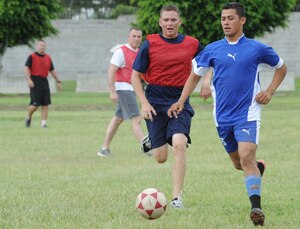 The Honduran soccer team (in red) face off against The U.S. Joint Task Force-Bravo team during an organization day July 22, 2011 at Soto Cano Air Base, Honduras. The purpose of the event was to provide team building between U.S. and Honduran military and civilians. The events of the day began with a two-mile run and included a triathlon, soccer, volleyball, water volleyball, basketball, dodge ball, a litter carry competition and funny dive. (U.S. Air Force photo/Tech. Sgt. Matthew McGovern)
