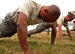 Tech. Sgt. Kurt Wells grunts through as many push-ups as he can muster during Air Mobility Rodeo 2011 July 26, 2011, at Joint Base Lewis-McChord, Wash.  Comptrollers from 11 teams Air Force-wide ran a confidence course, and were timed and tested on their memory, fitness, weapon assembly and chemical warfare skills. Wells is the NCO in charge of financial analysis with the 375th Comptroller Squadron, Scott Air Force, Ill. (U.S. Air Force photo/Senior Airman Abigail Klein)
