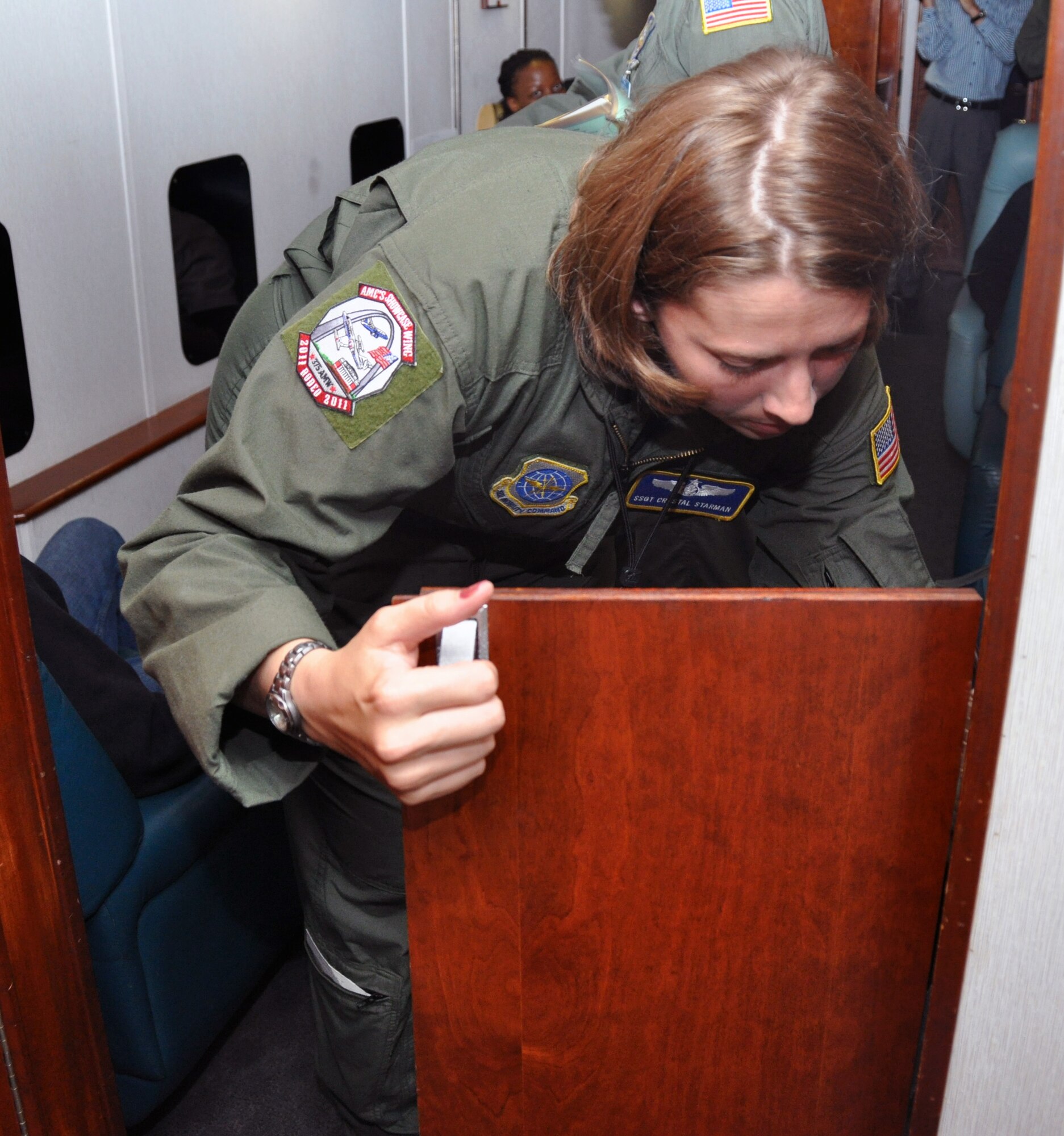Staff Sgt, Crystal Starman, 54th Airlift Squadron flight attendant, prepares the aircraft for a crash landing during a simulated flight at the Air Mobility Rodeo 2011, which is held at Joint Base Lewis-McChord, Wash. (U.S. Air Force photo/Airman 1st Class Michael Battles)