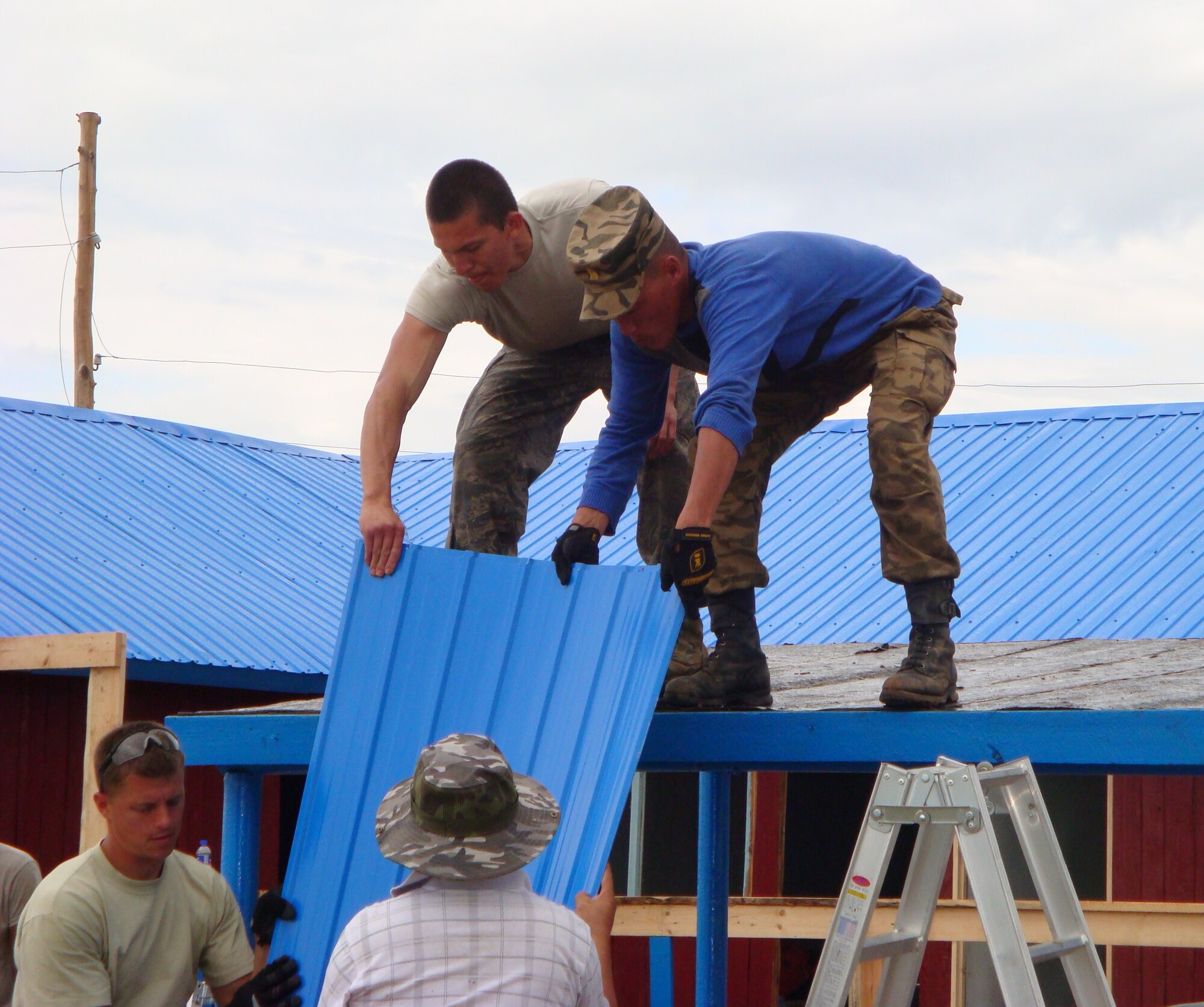 As part of the first Pacific Angel operation in Mongolia, U.S. Air Force and Mongolian army military engineers work side-by-side with local contractors July 19, 2011, to repair and renovate a clinic for Mongolian armed forces veterans and retirees in Tsenkermandal village.  In its fourth year, Pacific Angel cultivates bonds and fosters goodwill between the U.S. and Asian-Pacific countries through capacity-building in humanitarian assistance.  (U.S. Air Force photo/Lt. Col. Tracey Saiki)