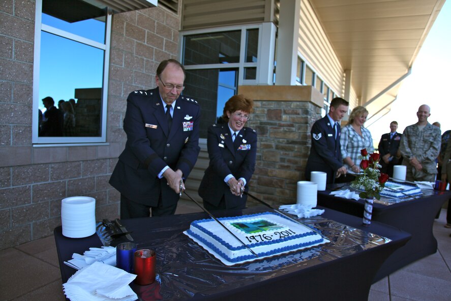 Following the ribbon cutting for the new Air Reserve Personnel Center at Buckley Air Force Base July 19, Lt. Gen. Charles E. Stenner, commander of Air Force Reserve Command, (left) and Col. Pat Blassie, ARPC commander, cut the cake that represents Air Reserve Personnel Center’s present time at Lowry Air Force Base, 1976-2011. (U.S. Air Force photo/ Quinn Jacobson, ARPC/PA)
