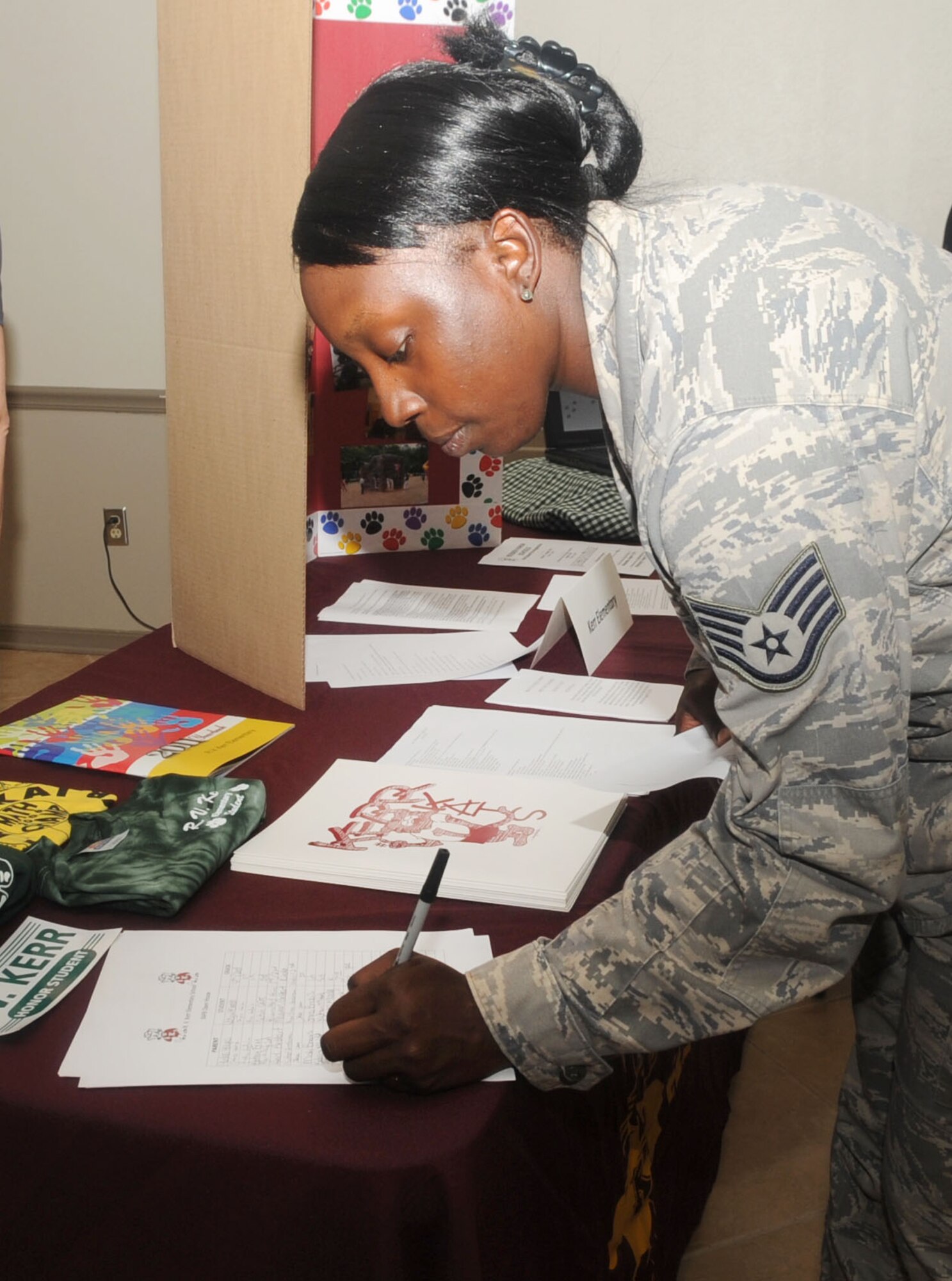 Staff Sgt. Tinisha Lawson, 2nd Force Support Squadron, fills out an e-mail roster for her daughter's school at the Back to School night at Hoban Hall on Barksdale Air Force Base, La., July 25. The event provided parents an opportunity to speak with school officials from the community about the different schools and the programs offered. (U.S. Air Force photo/Senior Airman Kristin High)(RELEASED) 