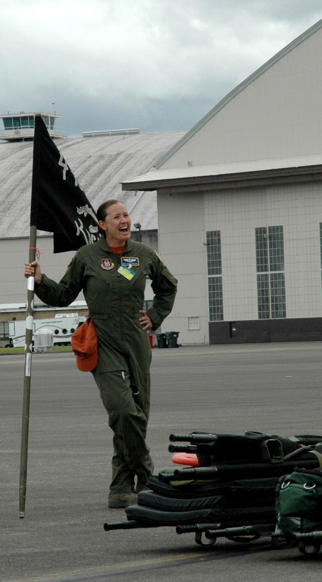 Master Sgt. Kristy Wellman, 446th Aeromedical Evacuation Squadron, cheers on the 446th Airlift Wing's Rodeo aeromedical evacuation team July 26. The team competed in the KC-135 aeromedical evacuation configuration event, requiring them to set up the interior of the KC-135 for aeromedical evacuation. (U.S. Air Force photo by Sandra Pishner)
