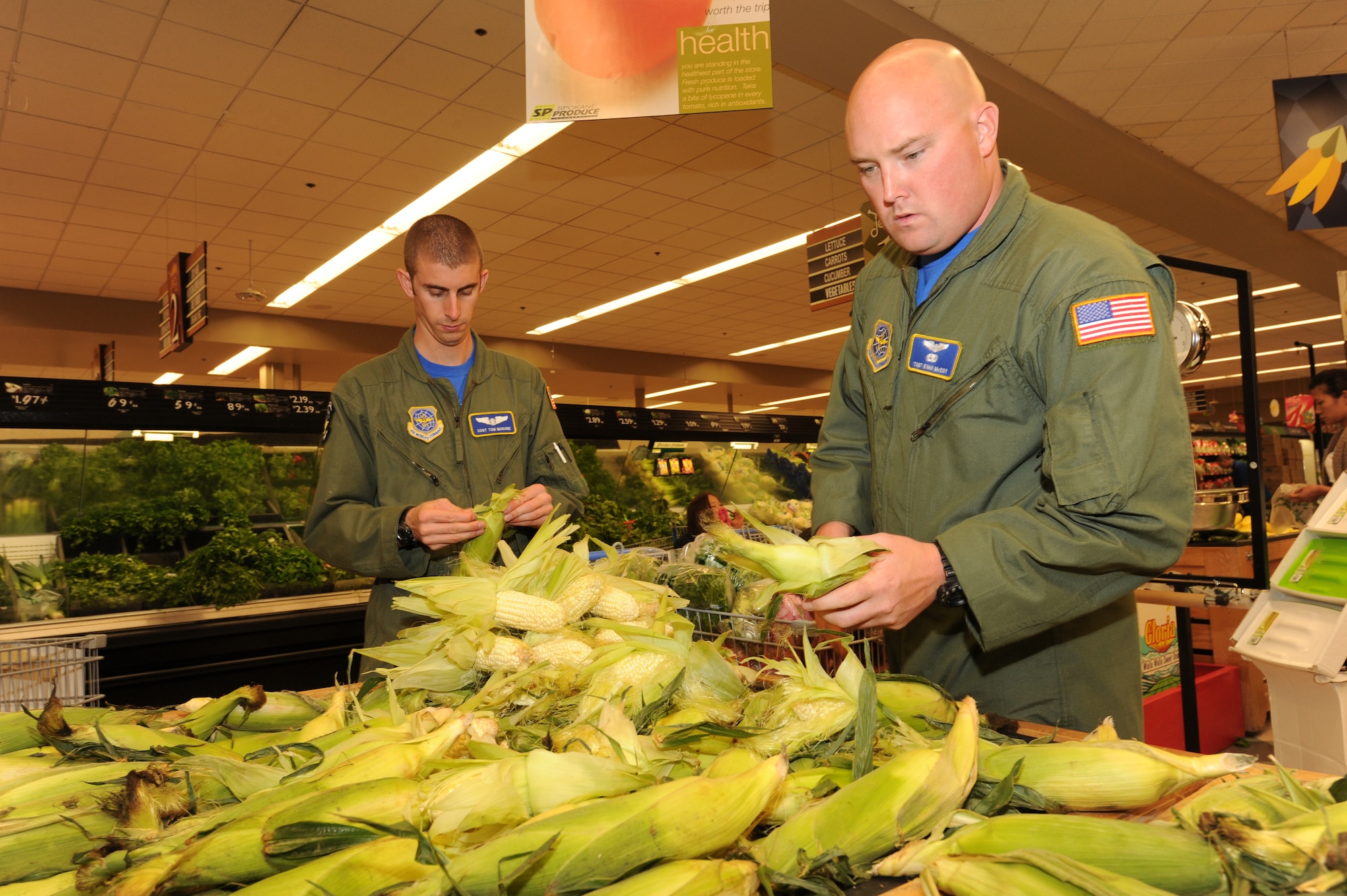 U.S. Air Force Tech. Sgt. Evan McCoy and Staff Sgt. Thomas Morone, both flight attendants, from Mac Dill Air Force Base, Fla., buy corn at the commissary for the culinary skills competition at Air Mobility Rodeo, Joint Base Lewis-McChord, Wash., on July 25, 2011. Rodeo is the U.S. Air Force's and Air Mobility Command's premier international combat skills and flying operations competition designed to develop and improve techniques, procedures, and interoperability, while optimizing international mobility partnerships and enhancing mobility operations. The flight attendant challenge at Rodeo consists of a timed aircraft evacuation and culinary skills competition. (U.S. Air Force photo by Tech. Sgt. Christine Jones/Released)