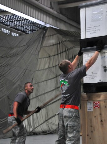 Airmen ensure their pallet meets the height requirement of a specific air frame, July 25, 2011, at Joint Base Lewis-McChord, Wash., during a pallet build-up competition. The event was part of Air Mobility Rodeo 2011, a biennial international competition that focuses on mission readiness, featuring airdrops, aerial refueling and other events that showcase the skills of mobility crews from around the world. (U.S. Air Force photo/Airman 1st Class Jared Trimarchi) 