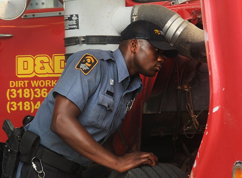 Derrick Trotter, Pinkerton Government Services Incorporated gate guard, inspects a semi-truck at the East Gate on Barksdale Air Force Base, La., July 25. The guards inspect vehicles to ensure they are compliant with installation rules and regulations prior to allowing them entry to the installation. (U.S. Air Force photo/Senior Airman Kristin High)(RELEASED)