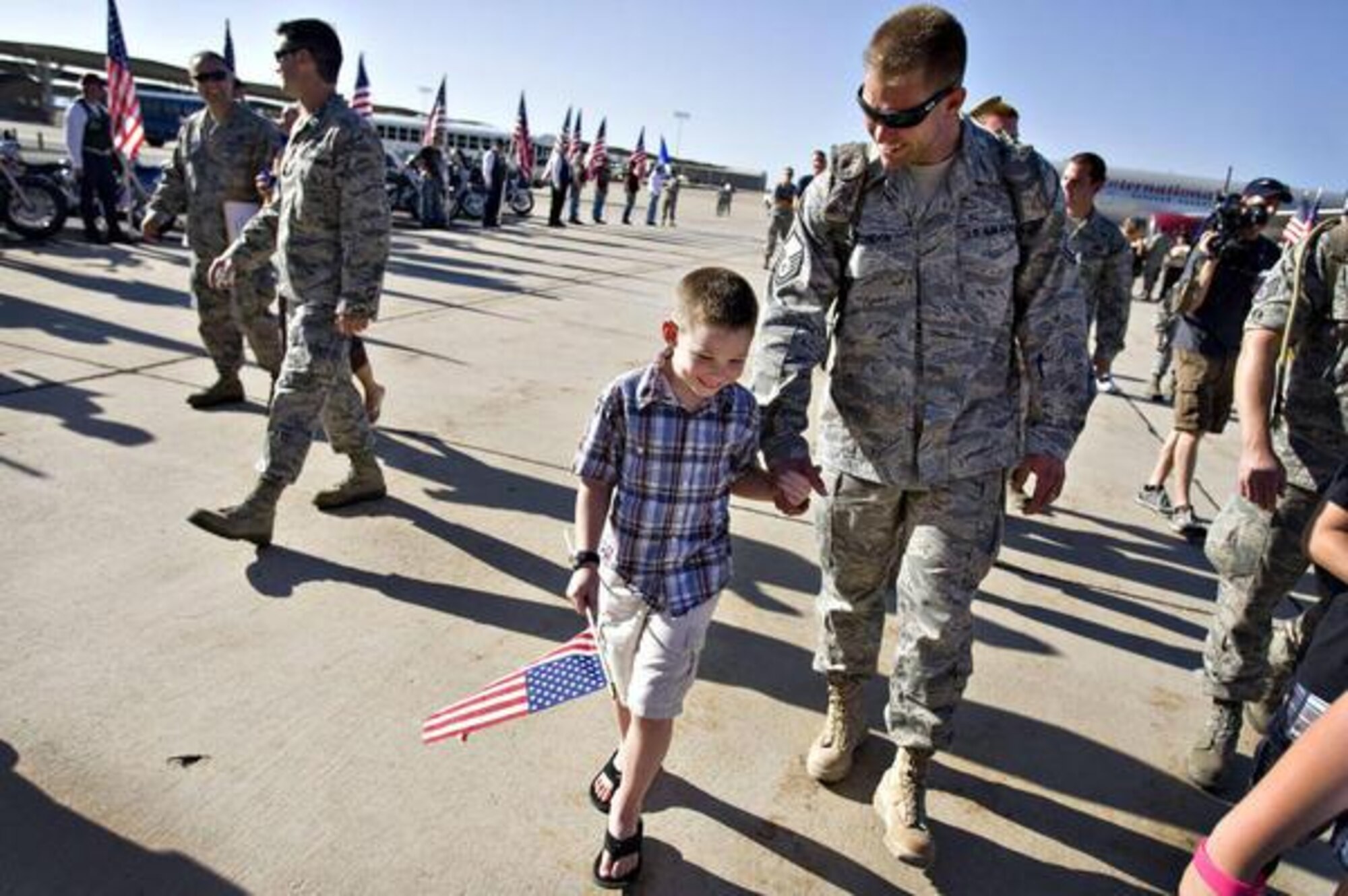 Master Sgt. Michael Condon walks with his son Gavin Condon after returning from a six-month deployment in Afghanistan. The 729th Air Control Squadron of the U.S. Air Force returned home to Hill Air Force Base in Layton on Wednesday, July 20, 2011.